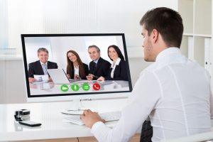 Businessman Videoconferencing On Desktop Computer